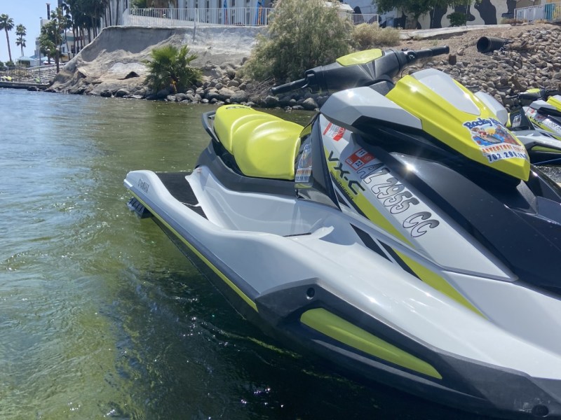 a motorcycle parked on the side of a river