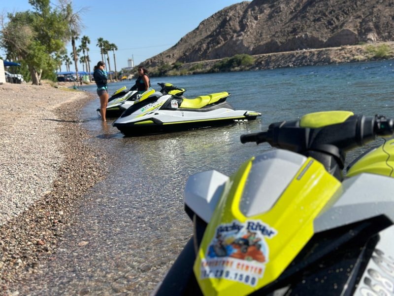 a motorcycle is parked on the side of the water