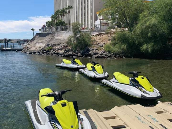 a yellow jet ski sitting on top of a body of water
