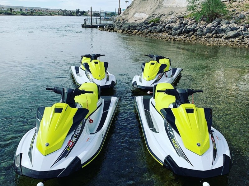 a yellow boat sitting on top of a motorcycle